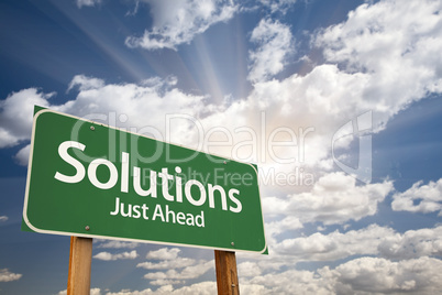 Solutions Green Road Sign Over Clouds