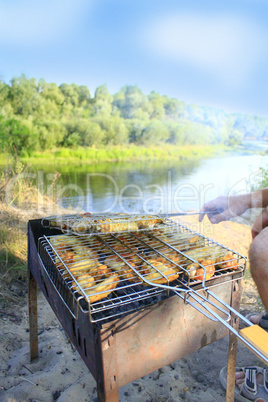 man cooks barbecue from hen's meat