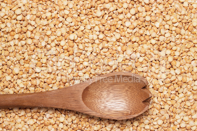 wooden spoon over peas background