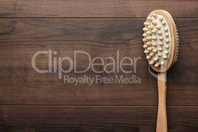 wooden massager brush on the table