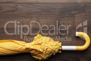 folded yellow umbrella on the table