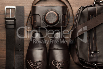 brown shoes, belt, bag and film camera