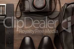 brown shoes, belt, bag and film camera frame