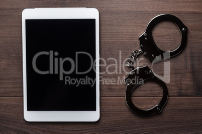 handcuffs and tablet computer