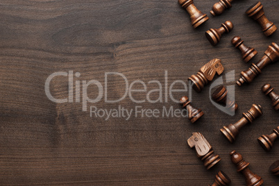 chess figures on brown wooden table background