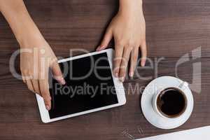 women hands with tablet computer and coffee on table
