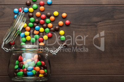 overturned glass jar full of colorful sweets