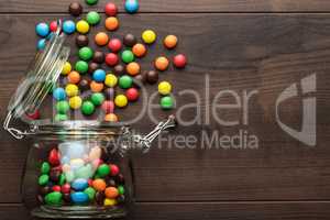 overturned glass jar full of colorful sweets