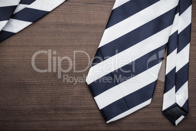 black and white striped necktie on wooden table