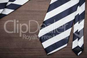 black and white striped necktie on wooden table