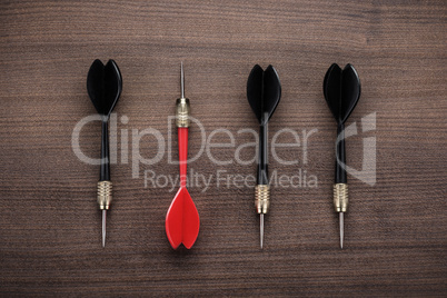red dart uniqueness concept on wooden background
