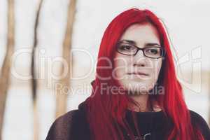 red-haired woman standing near the river