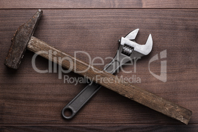 old rusty hammer and wrench on the table