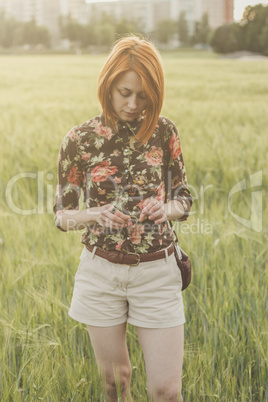 girl and green field in the evening