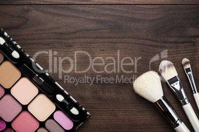 white make-up brushes on wooden background