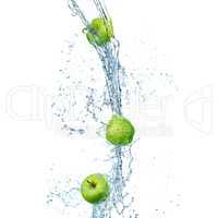 green apples in splash of water isolated