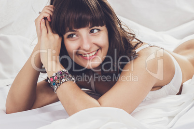 beautiful brunette girl in her bed