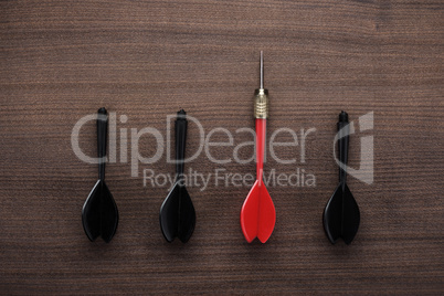 red dart uniqueness concept on wooden background