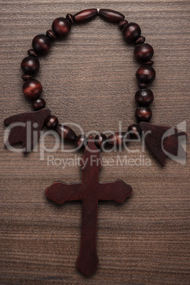 wooden cross on brown table background