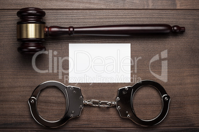 handcuffs and judge gavel on wooden background