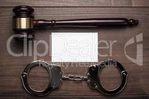 handcuffs and judge gavel on wooden background