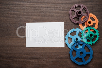 colorful gears on the brown wooden background
