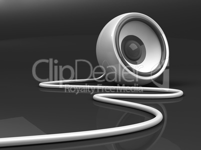 white speaker with cable over grey background