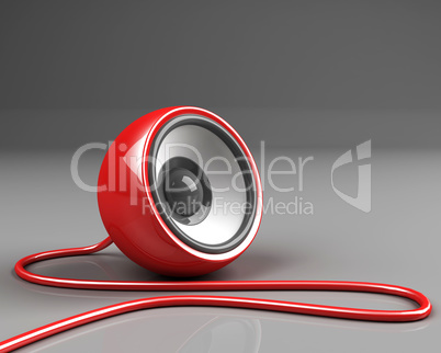 red speaker with cable over grey