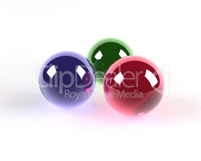three glass coloured spheres