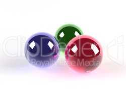 three glass coloured spheres