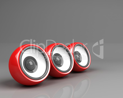 three red speakers over grey