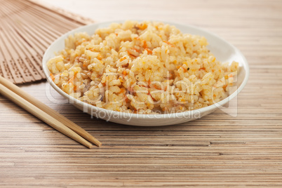 bowl of cooked rice with chopsticks