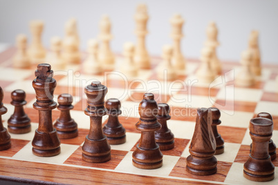 chess board with figures over grey background