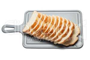 sliced bread on breadboard isolated over white