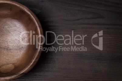 wooden salad bowl on the brown table