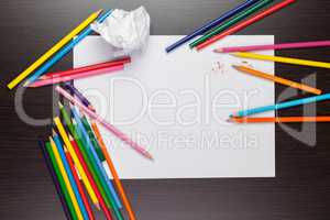 blank sheet of paper with colorful pencils creative process