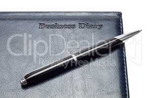 close-up of business diary with pen isolated over white