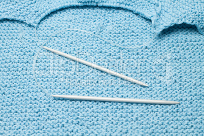 grey knitting needles on the knitted background