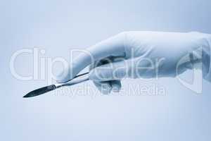 hand of surgeon with scalpel during surgery