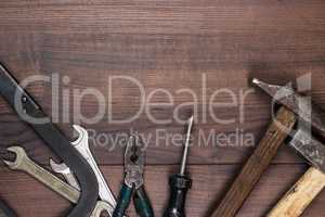 rusty construction tools on the wooden background