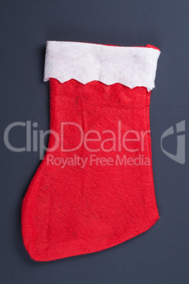 santas red stocking over grey background christmas concept