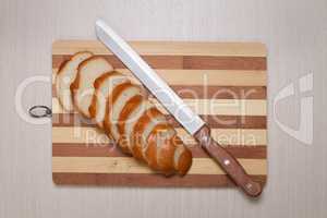 sliced bread on breadboard and knife