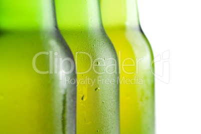 three green beer bottles on the white background isolated