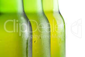 three green beer bottles on the white background isolated