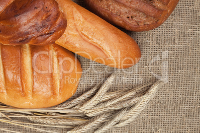 variety of fresh bread with ears of rye