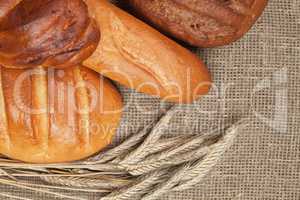 variety of fresh bread with ears of rye