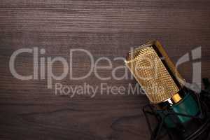 vintage condensing microphone on the wooden background