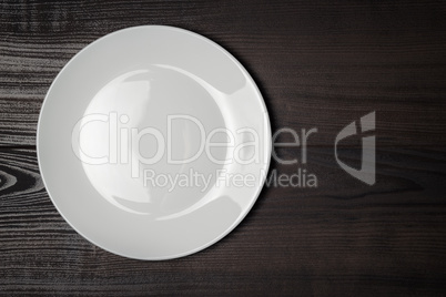 white plate on the wooden brown table