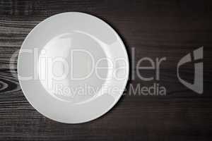 white plate on the wooden brown table