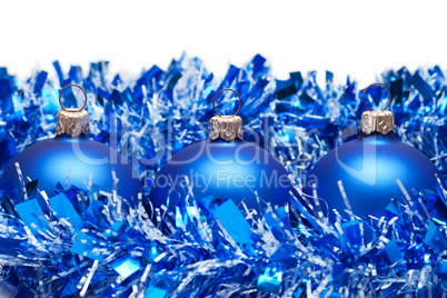 blue christmas balls with tinsel isolated over white background
